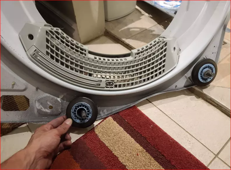 lg-dryer-making-noise-dryer-repair-panel-removed-on-the-ground-wheels-showing